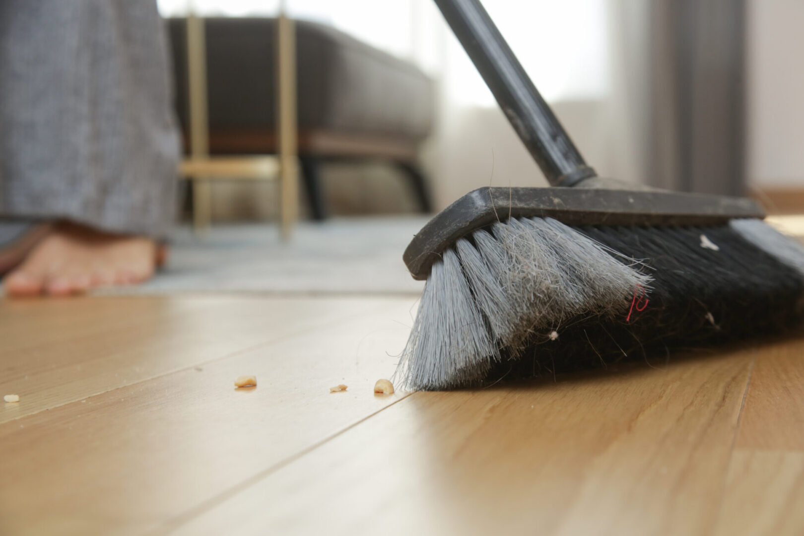 Broom cleaning hardwood surface