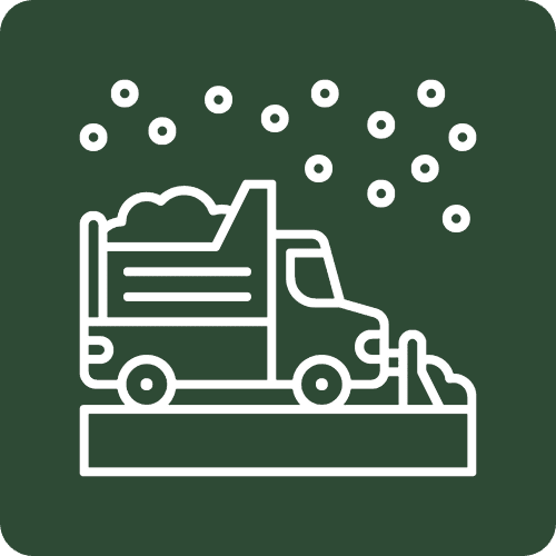 Snowplow truck clearing road with falling snow