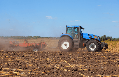 Tractor working in farmland