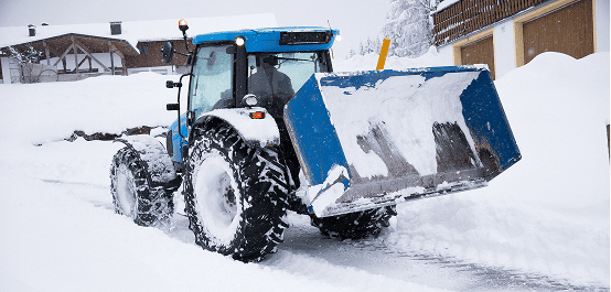 Snow-covered tractor in winter landscape