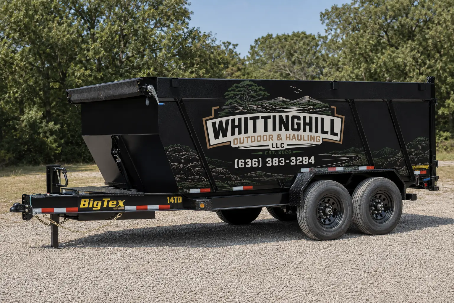 Black 2019 14' x 83' tandem axle dump trailer on the ground surrounded by grass and trees